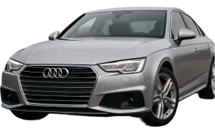 A silver Audi sedan is parked, viewed from the front left side. The car features the signature Audi grille, sleek headlights, and alloy wheels.