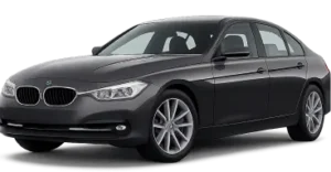 A dark gray BMW sedan is shown from a front-side angle. The car has sleek lines, prominent headlights, and the iconic BMW kidney grille. The vehicle is parked on a plain background.