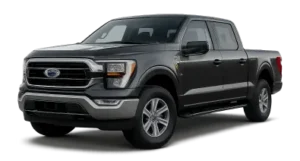 A black Ford F-150 pickup truck with four doors is parked on a plain background, facing slightly to the left. The truck features chrome accents on the grille and bumper.