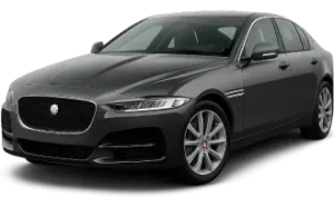 A sleek, dark gray Jaguar sedan is shown from a front-side angle, highlighting its modern design, distinctive headlights, chrome accents, and alloy wheels on a plain background.
