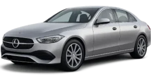 A silver sedan car is parked at an angle, showcasing its sleek design, prominent front grille, and alloy wheels.