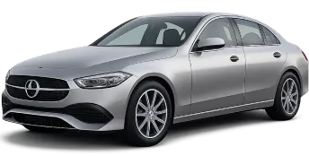 A silver sedan car is parked at an angle, showcasing its sleek design, prominent front grille, and alloy wheels.
