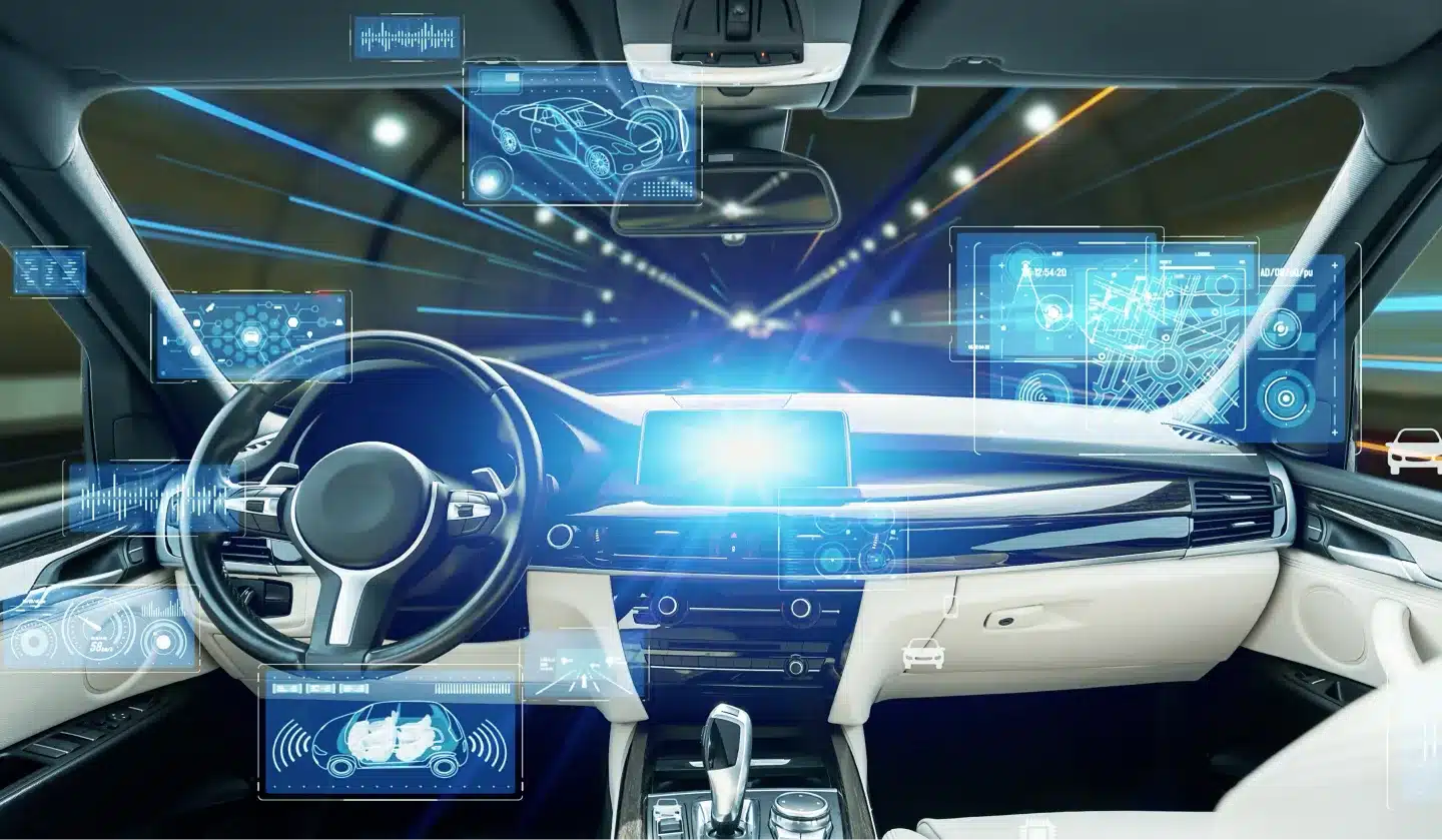 Futuristic car interior with digital dashboards and holographic displays, showcasing autonomous driving features. The car drives through a tunnel, illuminated by blue light trails and high-tech interface graphics.