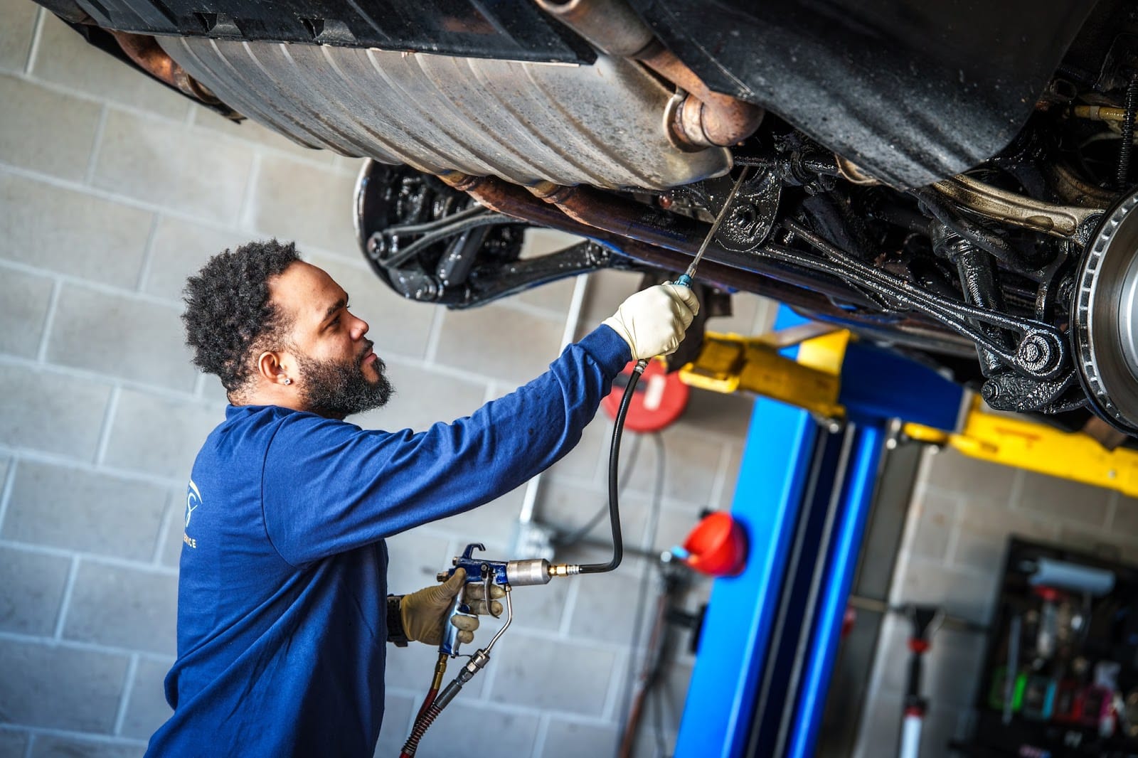 NHOU Undercoating service in Newbury, MA by Angie's Service. Image showing a technician applying protective undercoating beneath a vehicle, emphasizing rust prevention and long-term durability.