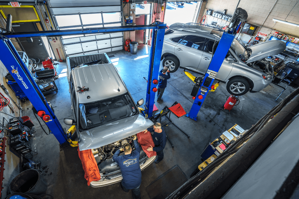 Winter car prep, auto repair in Newbury, MA by Angie’s Service. Image of multiple vehicles on lifts with technicians performing inspections and repairs. Highlighting Angie’s Service’s commitment to thorough workmanship, reliability, and driver safety.
