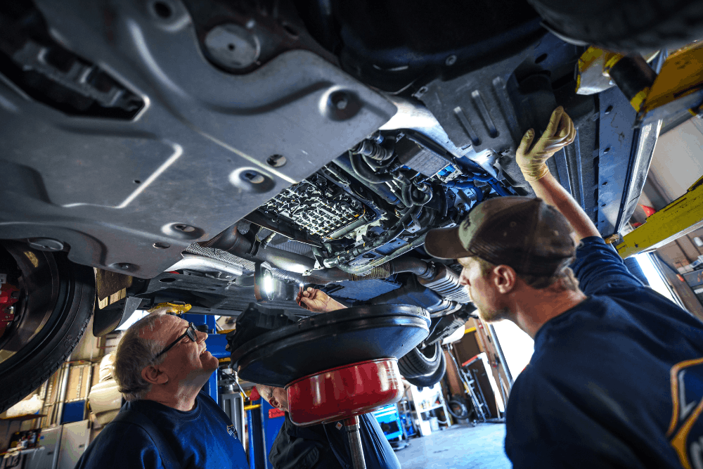 Auto repair near Newburyport, MA by Angie’s Service Inc. Image of technicians working beneath a vehicle on a lift, highlighting transmission maintenance, fluid service, and detailed undercar diagnostics to ensure smooth performance and long-term reliability.