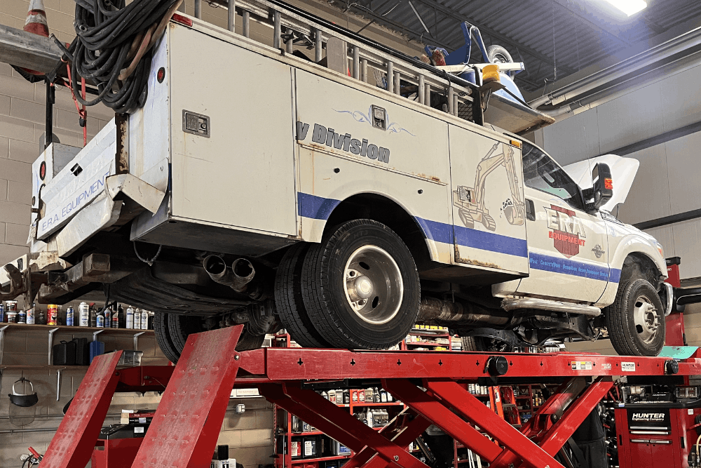 Fleet maintenance, auto repair in Newbury, MA at Angie’s Service Inc. Image of commercial service truck on a lift during professional fleet repair and preventative maintenance, helping businesses keep work vehicles reliable and road-ready.