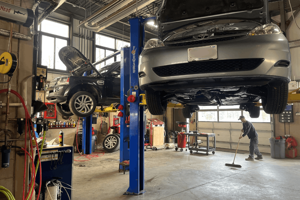 Auto repair in Newbury, MA, at Angie's Service Inc. Image of multiple vehicles being serviced on lifts inside the repair shop, highlighting expert maintenance and repairs that keep vehicles performing safely and reliably.